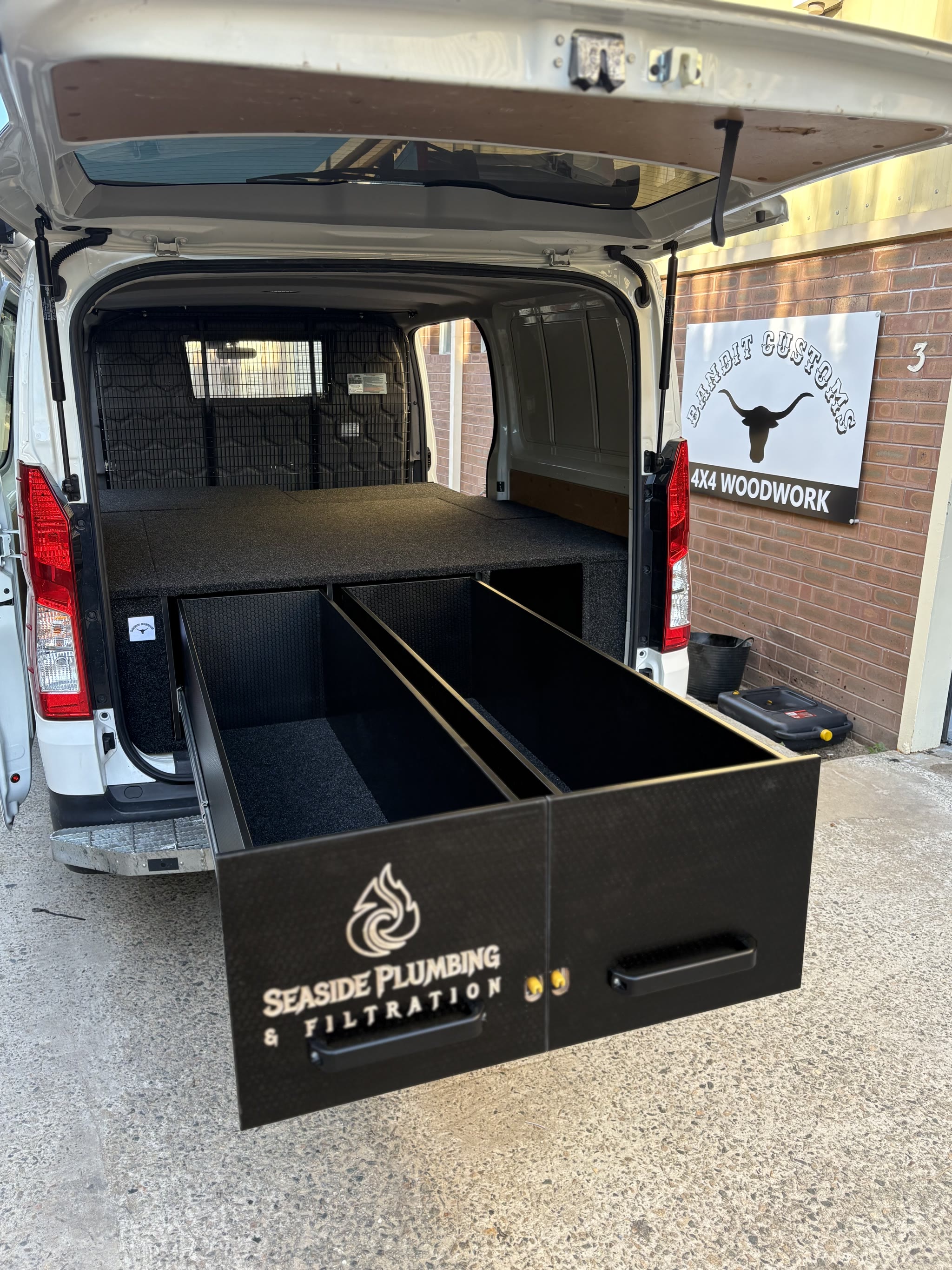 Seaside Plumbing van, long drawer out over the bumper